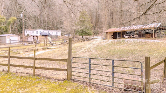 view of yard with an outbuilding and a rural view