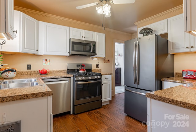 kitchen featuring white cabinets, appliances with stainless steel finishes, and dark wood-type flooring