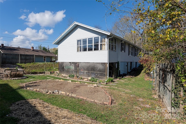 view of side of home featuring a lawn