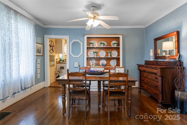 dining room featuring wood finished floors, visible vents, and ornamental molding