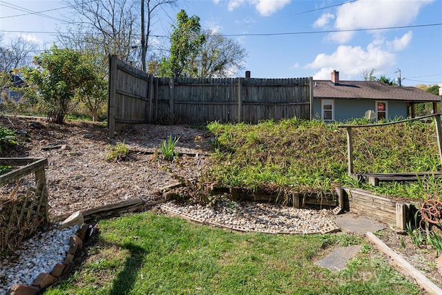 view of yard with a garden and fence