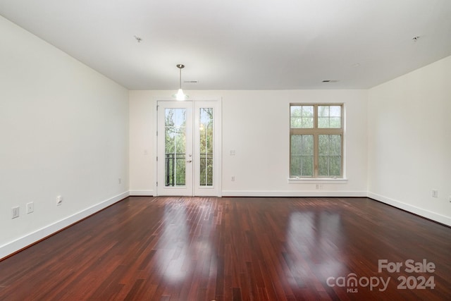 unfurnished room with dark hardwood / wood-style floors