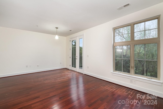 unfurnished room with dark hardwood / wood-style floors