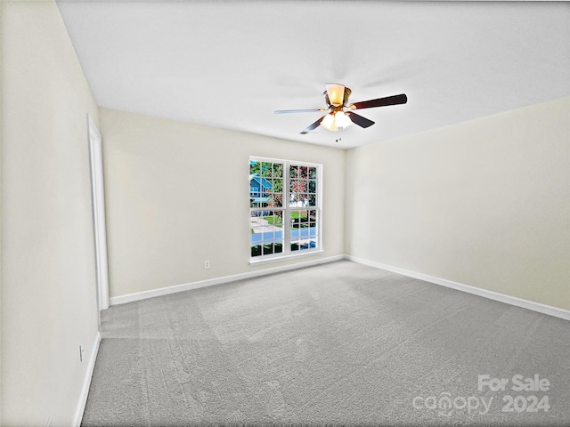 carpeted spare room with ceiling fan