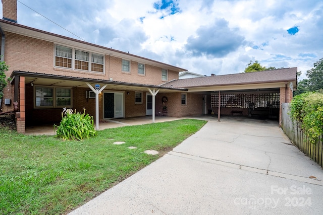 front of property featuring a carport and a front lawn