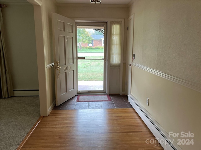 tiled foyer featuring a baseboard heating unit