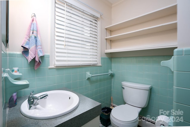 bathroom featuring vanity, tile walls, crown molding, and toilet