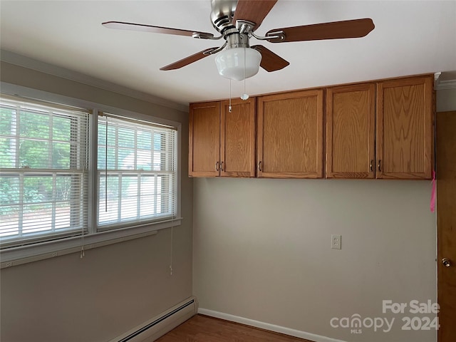 interior space featuring ornamental molding, hardwood / wood-style flooring, a baseboard heating unit, and ceiling fan