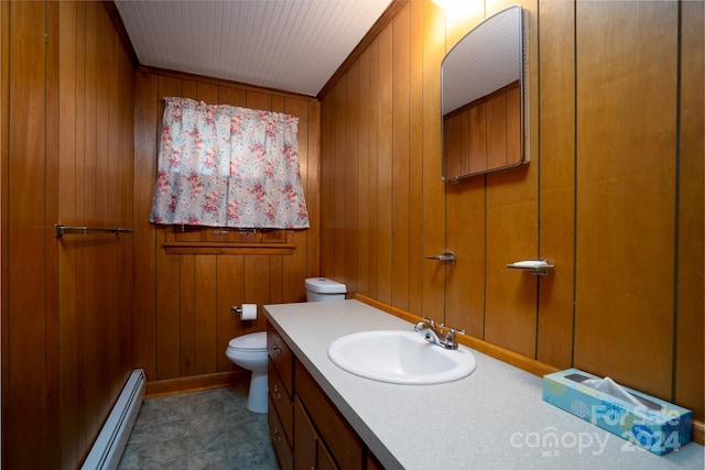 bathroom with wood walls, a baseboard radiator, vanity, and toilet