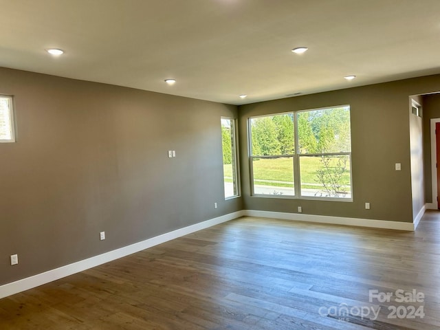 unfurnished room with hardwood / wood-style flooring