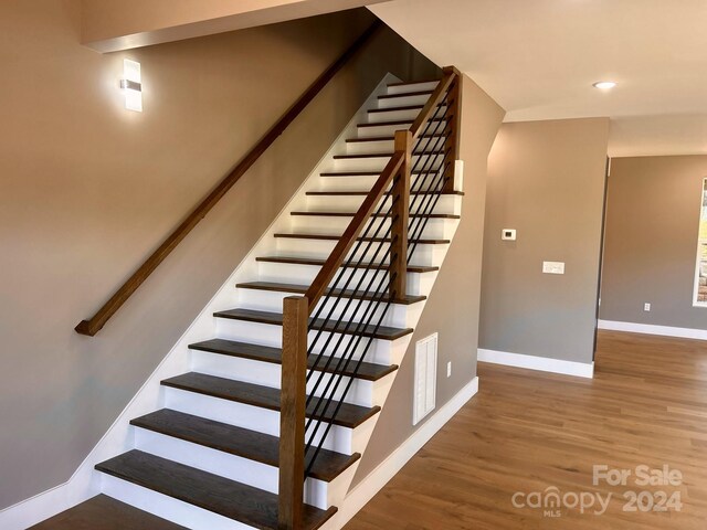 1243 10th Street Pl NW, Hickory, NC 28601 - stairway with baseboards, wood finished floors, and recessed lighting
