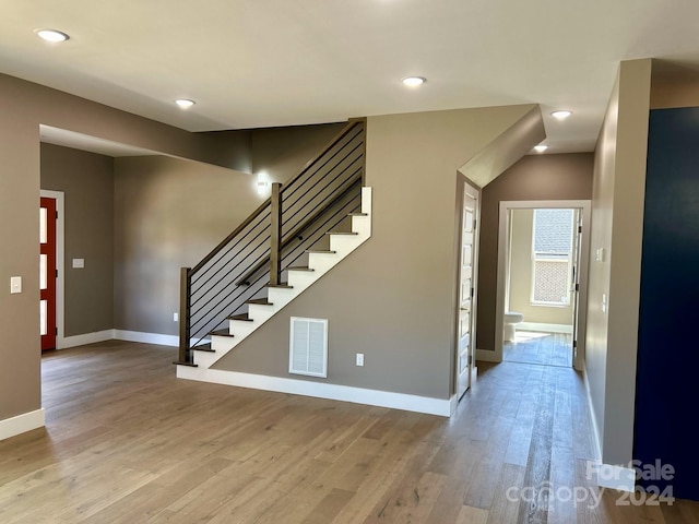 stairway featuring wood-type flooring