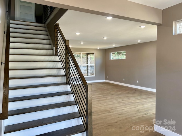 staircase with hardwood / wood-style flooring