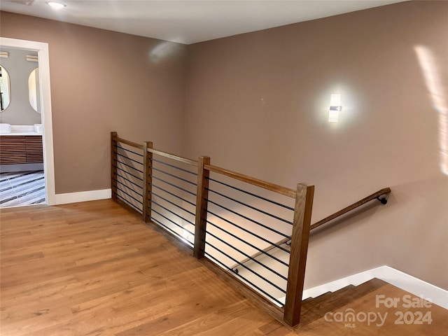 staircase with hardwood / wood-style flooring