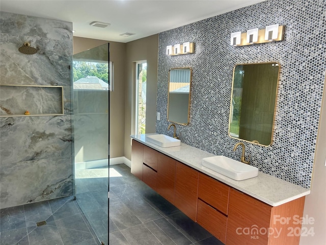 bathroom featuring tile walls, tile patterned floors, vanity, and tiled shower