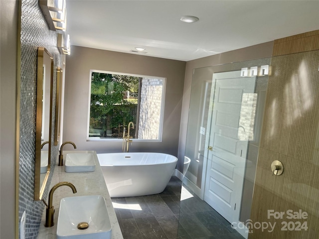 bathroom featuring separate shower and tub, sink, and tile patterned floors