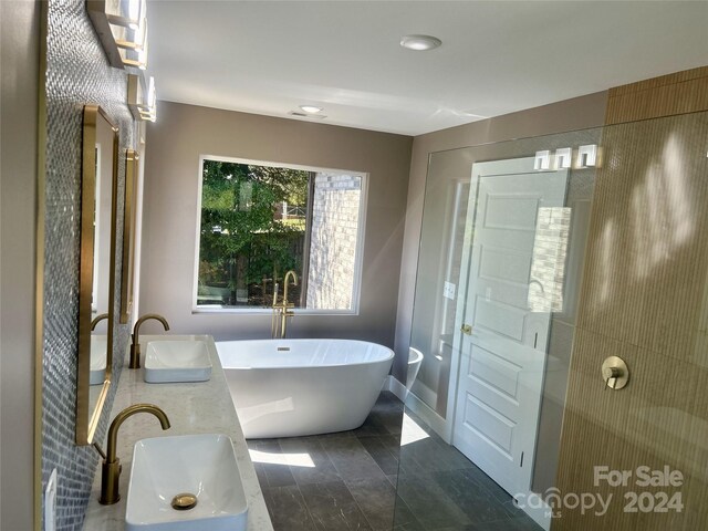 1243 10th Street Pl NW, Hickory, NC 28601 - bathroom featuring a sink, a soaking tub, baseboards, and recessed lighting