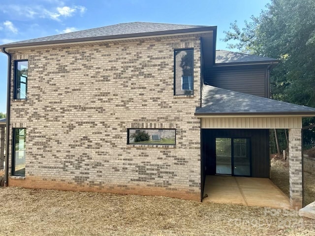 view of property exterior with a patio area