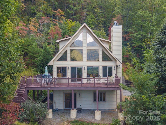 back of property featuring a wooden deck