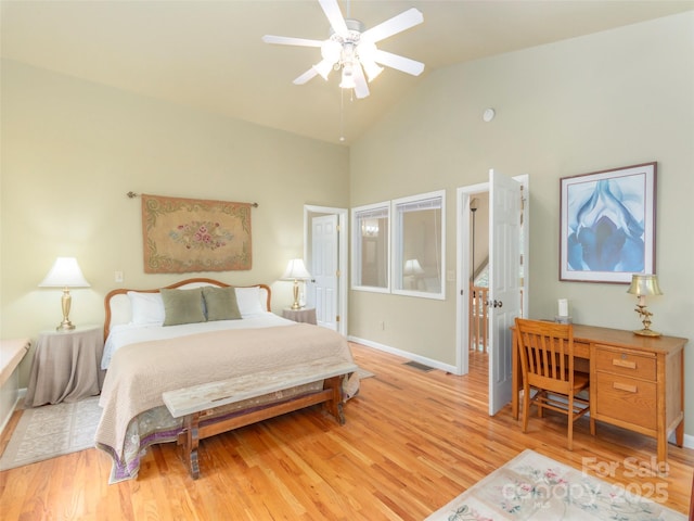 bedroom with ceiling fan, lofted ceiling, and light hardwood / wood-style floors