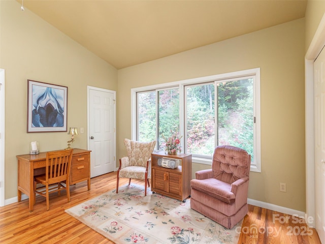 sitting room featuring lofted ceiling and light hardwood / wood-style floors