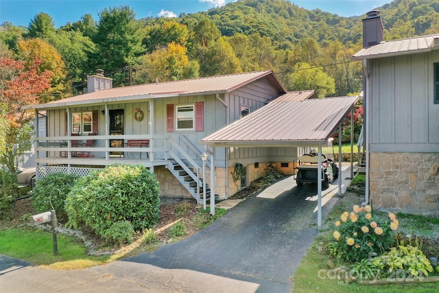 view of front of property featuring a porch and a carport