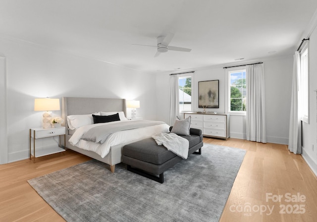 bedroom with light hardwood / wood-style floors and ceiling fan