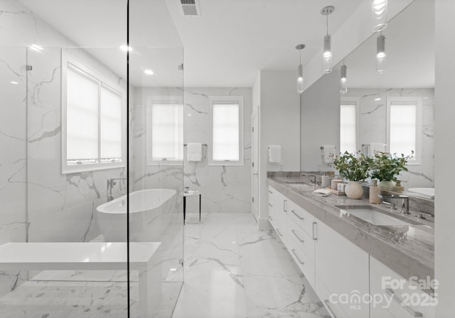 bathroom with vanity and separate shower and tub