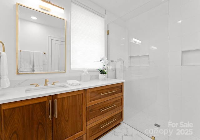 bathroom with vanity and tiled shower