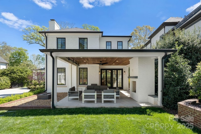 back of house featuring ceiling fan, a yard, outdoor lounge area, and a patio