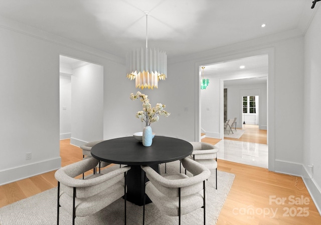 dining area with crown molding and wood-type flooring