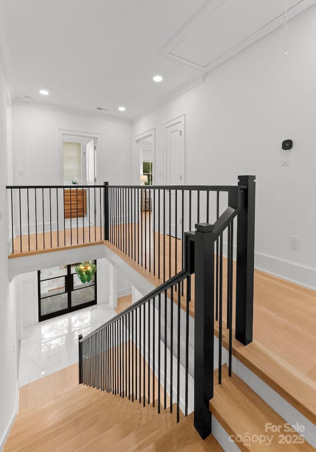 stairway with hardwood / wood-style floors and a wealth of natural light