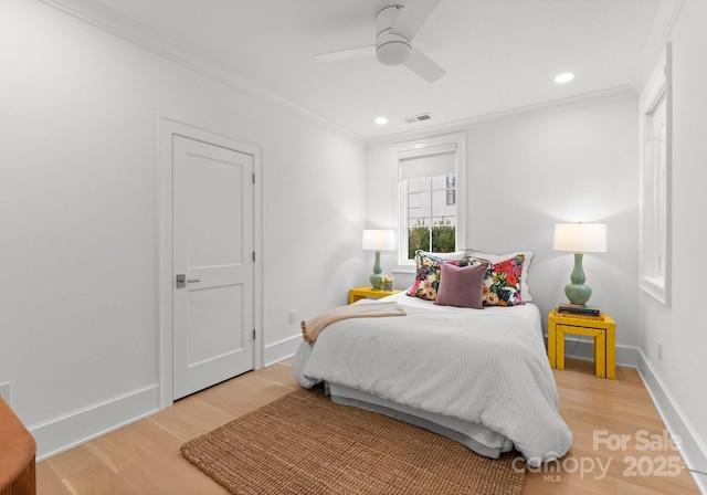 bedroom with ceiling fan, ornamental molding, and light wood-type flooring