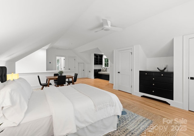 bedroom featuring ceiling fan, lofted ceiling, and wood-type flooring