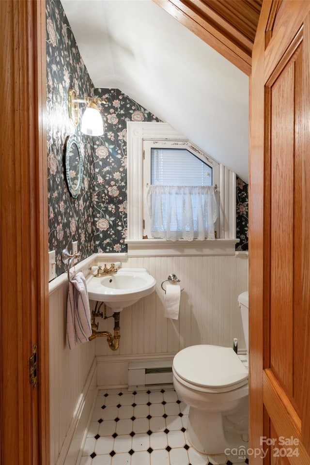 bathroom featuring toilet, lofted ceiling, sink, and a baseboard radiator