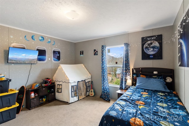 bedroom with a textured ceiling, carpet floors, and ornamental molding