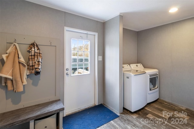 laundry room with separate washer and dryer and dark hardwood / wood-style flooring