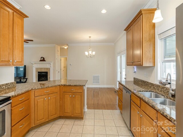 kitchen featuring a peninsula, a sink, ornamental molding, dishwasher, and brown cabinetry