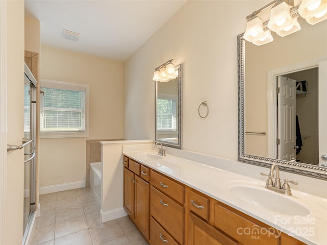 full bathroom featuring tile patterned flooring, visible vents, a sink, and a garden tub