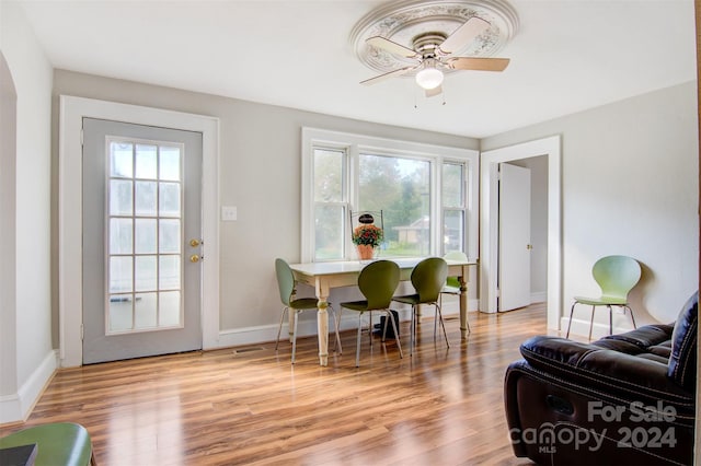 dining area with light wood-type flooring and ceiling fan