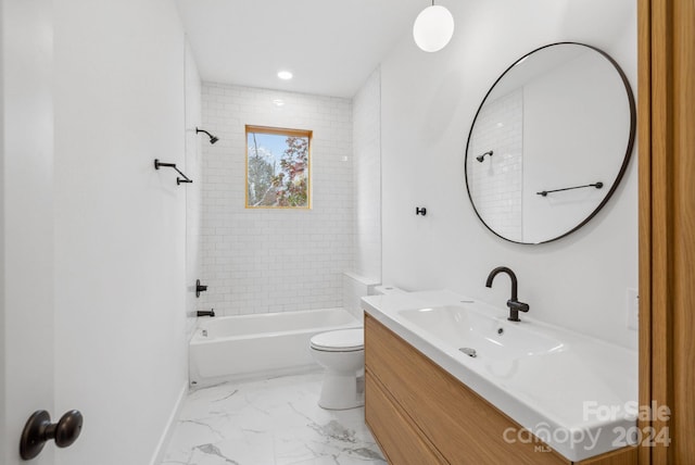 full bathroom featuring toilet, vanity, and tiled shower / bath