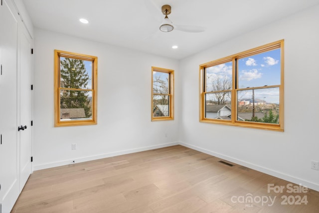 unfurnished room with ceiling fan and light hardwood / wood-style floors