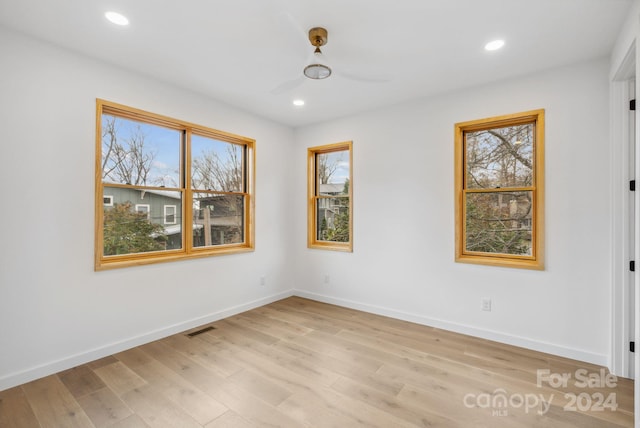 empty room featuring light hardwood / wood-style flooring and ceiling fan