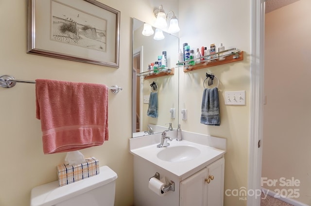 bathroom featuring toilet and vanity