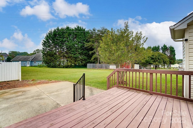 deck with a yard, a patio area, and fence