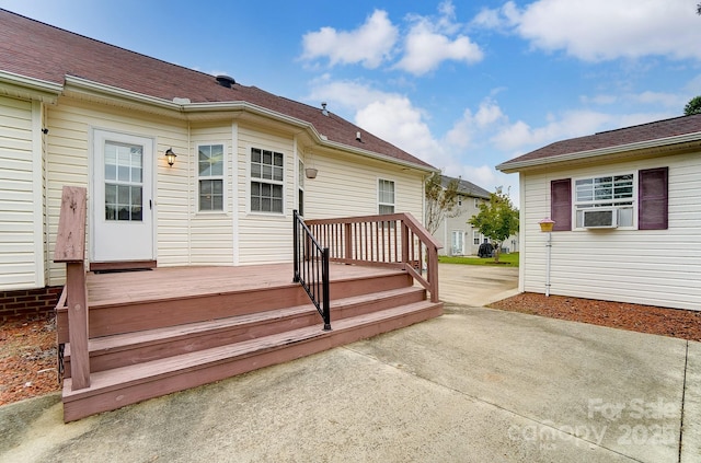 wooden deck with a patio and cooling unit