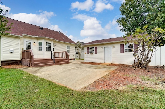 back of house with a patio area, a yard, a wooden deck, and fence