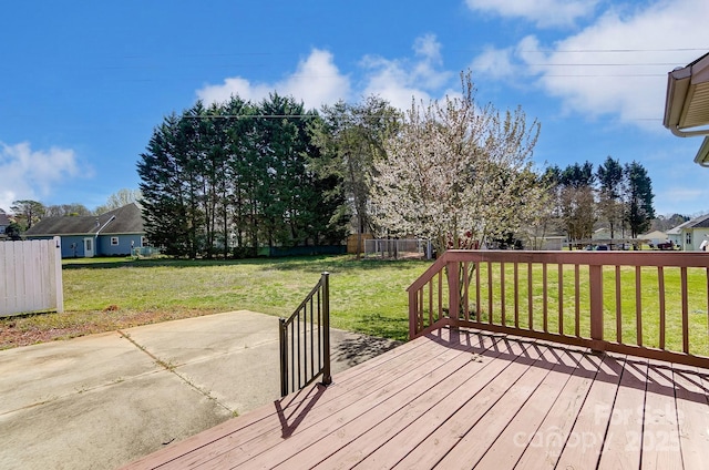 wooden deck with a lawn and fence