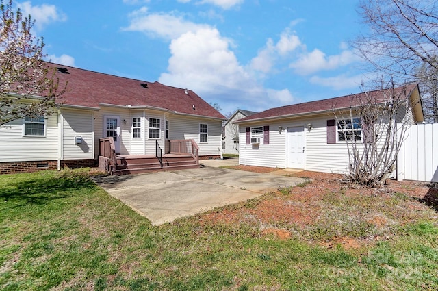 rear view of property with cooling unit, a yard, a patio, and a deck