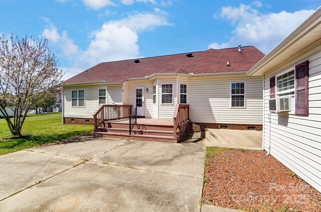 view of front of property with crawl space, a front yard, a patio area, and a deck